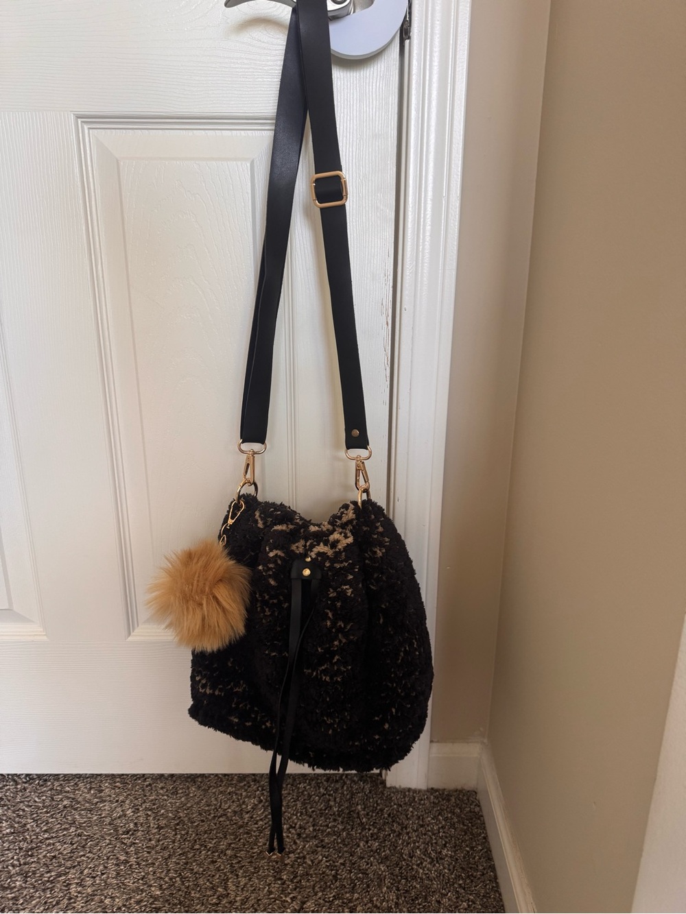 Black Faux-Shearling Drawstring Crossbody with Tan Pom Pom